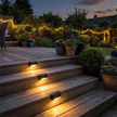 Solar step lights on wooden deck at dusk