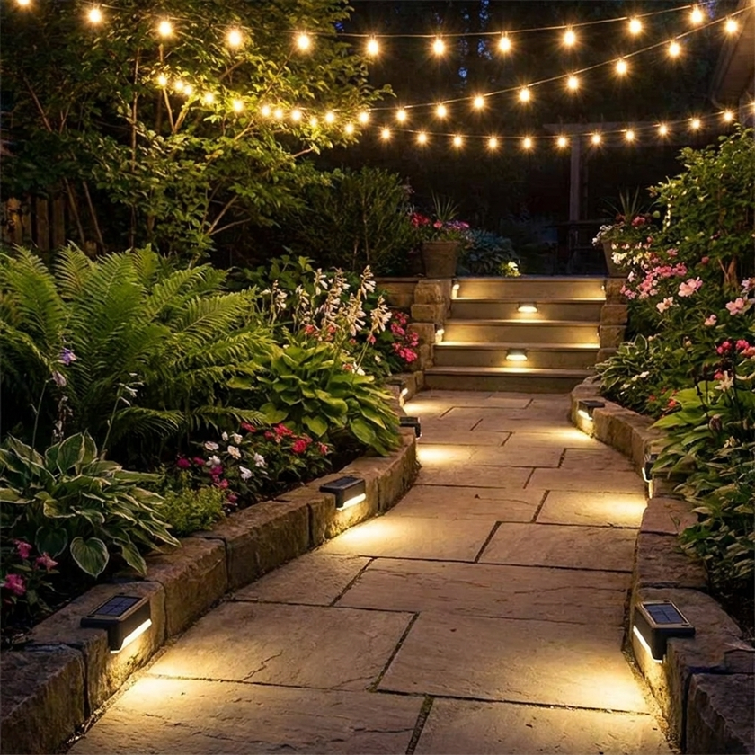 Solar step lights on garden pathway at night