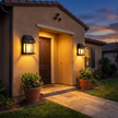 Solar wall sconces flanking front door at dusk